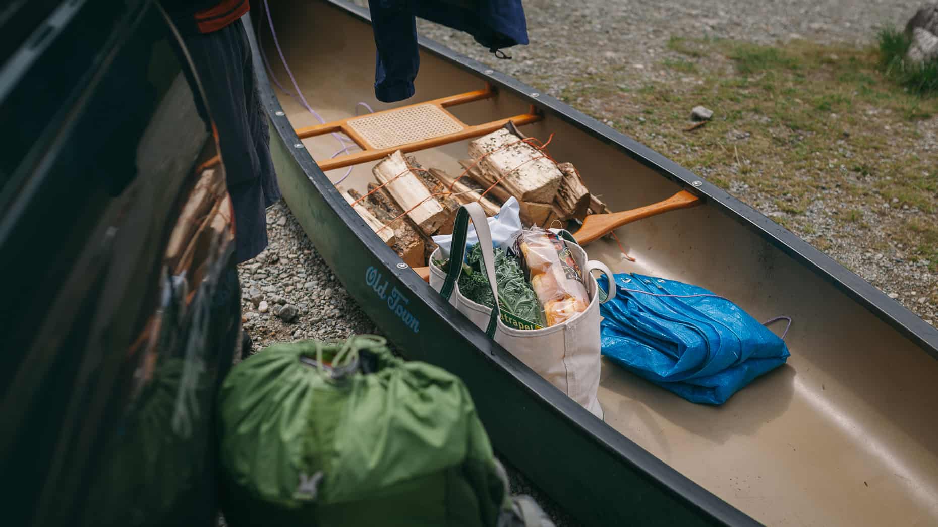 Old Town canoe loaded with firewood